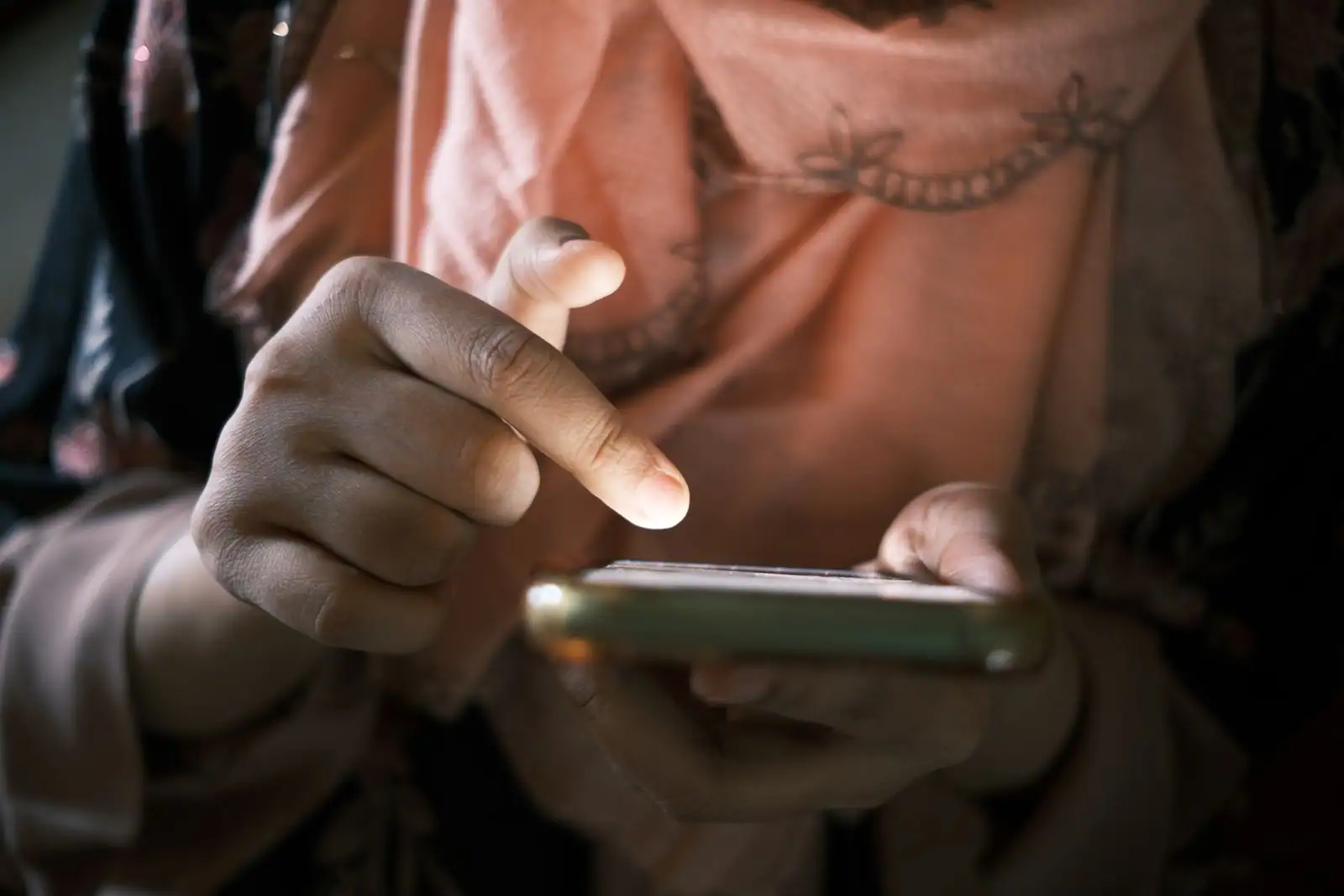 Une personne consulte son smartphone, le geste quotidien pour accéder à ses comptes en ligne.